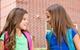 two girls talking outside school