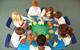 Photo of children in a classroom working in groups or pairs.