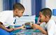 Photo of children playing a board game.